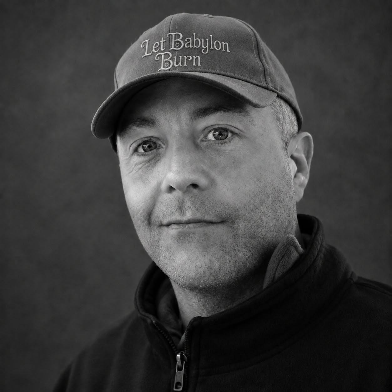 Robert Lancaster wearing a Let Babylon Burn cap